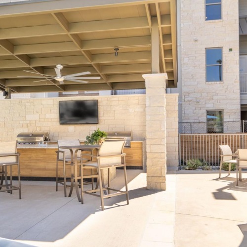 Access to resident-only features Outdoor grilling area at The Chloe Leander apartments in Leander, TX.